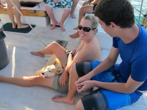Megan and Hermes and John lounging on deck.